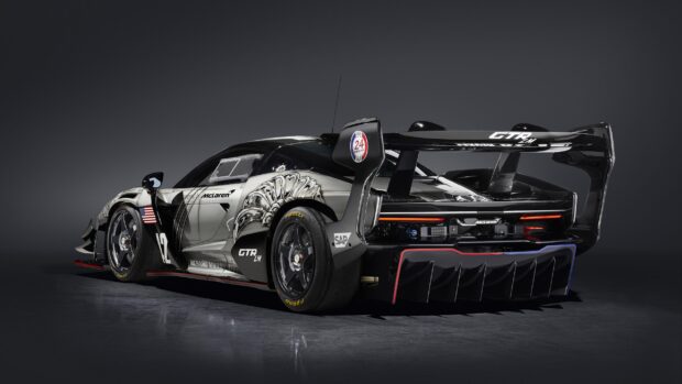 The McLaren Senna racing car has detailed bodywork with sponsor logos and aerodynamic features, 2K Desktop Wallpaper