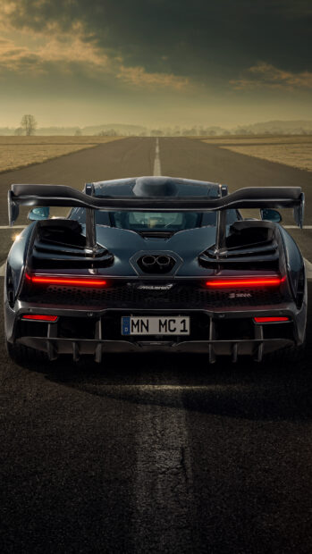 A McLaren Senna is parked on an empty road with a cloudy sky background, 4K Phone Wallpaper