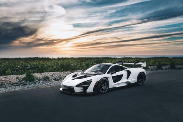 A Mclaren Senna is parked on a road with a dramatic sunset and cloudy sky, HD Desktop Wallpaper