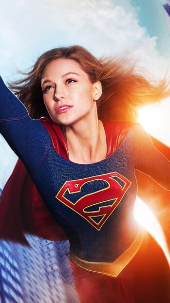 Melissa Benoist is dressed as Supergirl flying over the city with sunlight behind her, 4K Mobile Wallpaper