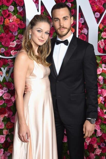 Melissa Benoist wallpapers show her in a satin dress standing next to a man in a tuxedo at an event, 2K PC Wallpaper