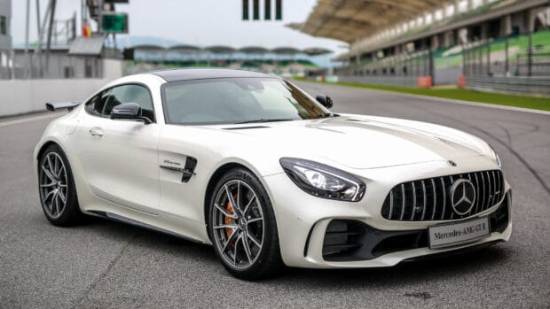 A white Mercedes Benz AMG GT R is parked on a race track with a grandstand in the background, HD Desktop Wallpaper