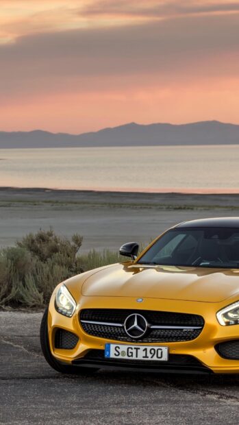 A yellow Mercedes Benz Amg Gt is parked near the beach during sunset, HD Phone Wallpaper