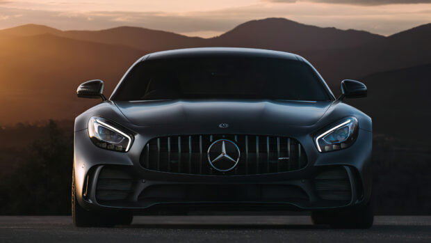 A black Mercedes Benz Amg Gt sports car is parked with mountains in the background at sunset, 4K Desktop Wallpaper