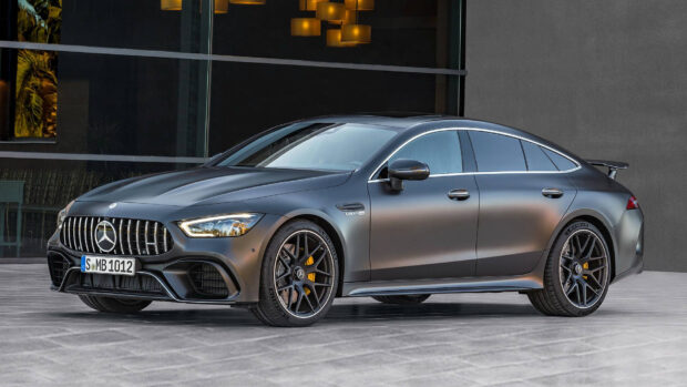 A matte black Mercedes Benz Amg Gt is parked in front of a modern building, HD Desktop Wallpaper