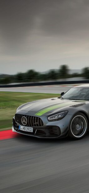 A Mercedes Benz Amg Gt car is driving fast on a race track with blurred background, 2K Phone Wallpaper