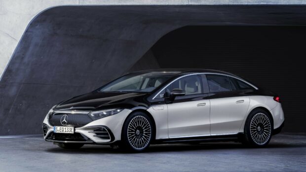 A silver and black Mercedes Benz EQS electric luxury sedan parked outside a modern building, HD Desktop Wallpaper