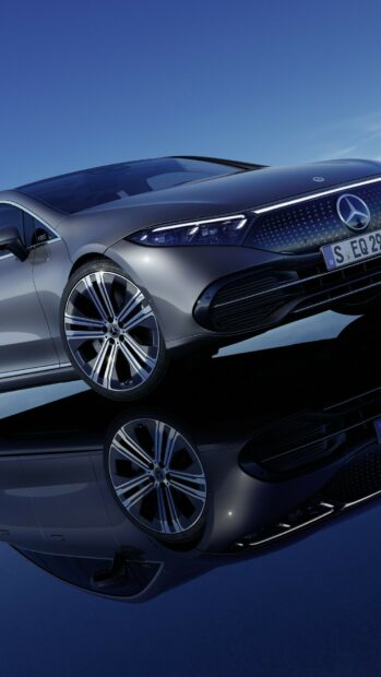 A silver Mercedes Benz EQS is shown with a clear reflection on the floor, highlighting its sleek design, HD Phone Wallpaper