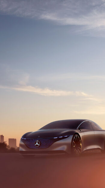A sleek Mercedes Benz EQS is shown with illuminated grille during sunset, 2K Phone Wallpaper