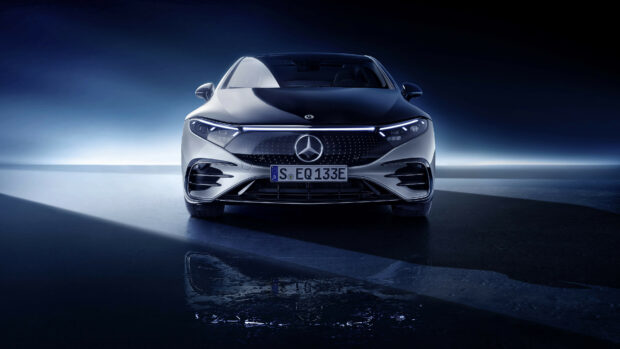 A silver Mercedes Benz Eqs is captured from the front with sleek headlights and logo, 4K Desktop Wallpaper