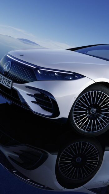 The Mercedes Benz Eqs is parked showing its front and wheel design under a clear blue sky, 2K Phone Wallpaper