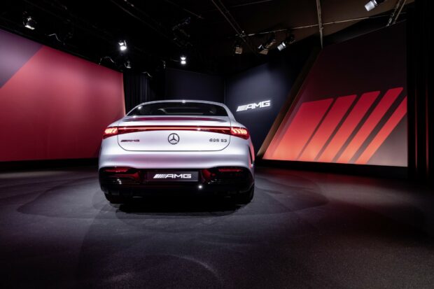 The rear of a Mercedes Benz Eqs car is displayed in a modern showroom with AMG branding, HD Desktop Wallpaper