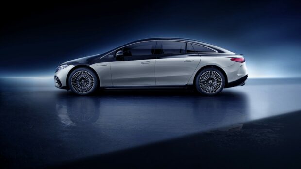 A silver Mercedes Benz Eqs is showcased in a dark modern setting with clear reflections, 2K Desktop Wallpaper