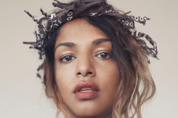 A close up portrait of Mia Rapper wearing a bandana and looking directly at the camera, HD Mobile Wallpaper