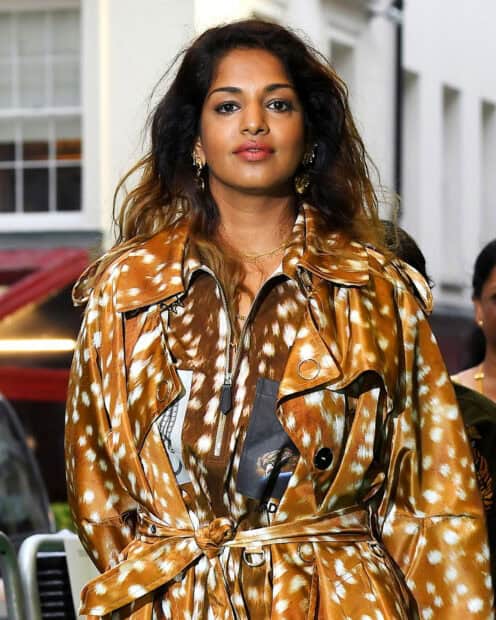 Mia Rapper Wallpapers featuring a confident woman in a patterned brown coat, HD Desktop Wallpaper
