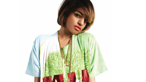 Mia rapper in a colorful shirt with gold chains posing against white background, HD Desktop Wallpaper