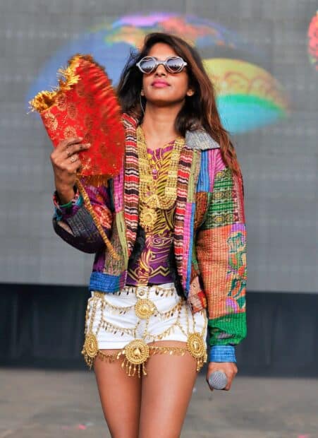 Mia rapper is wearing colorful clothes and holding a microphone, HD Mobile Wallpaper