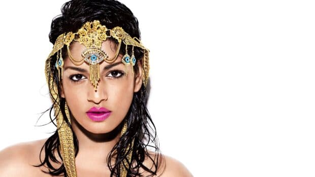 Mia rapper wears a unique gold headpiece with blue eye details, HD Desktop Wallpaper