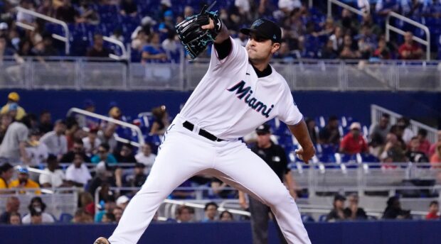 A Miami Marlins player is pitching the ball in a crowded stadium, HD Desktop Wallpaper