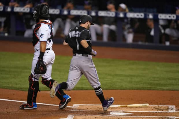 A Miami Marlins player steps onto home plate during a game, 2K Desktop Wallpaper