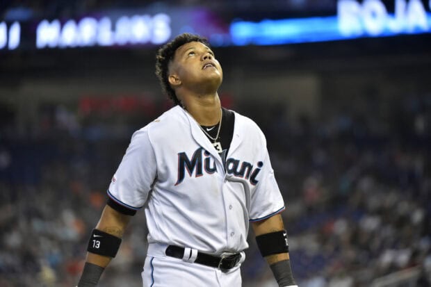 A Miami Marlins player looks upward intently during a game in the stadium, 2K Desktop Wallpaper