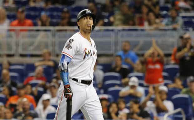 A Miami Marlins player stands on the field during the game with the crowd in the background, 2K Desktop Wallpaper