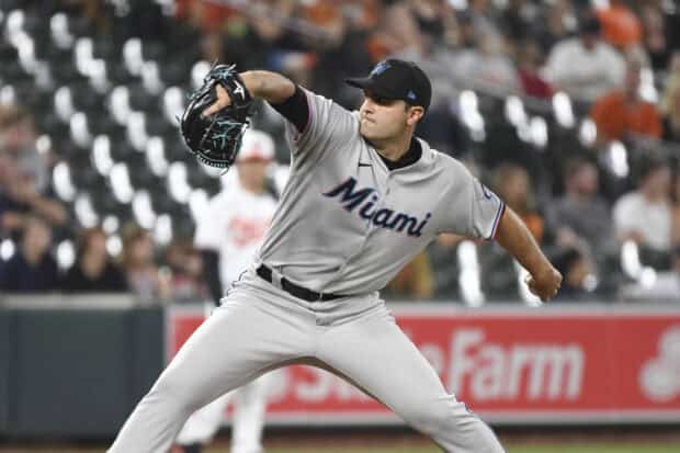 A Miami Marlins player is focused on pitching during a game, HD Desktop Wallpaper