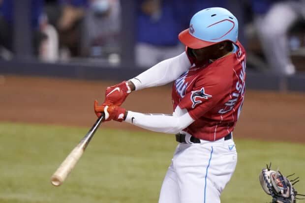 A Miami Marlins player is captured mid swing during a game, 2K Desktop Wallpaper