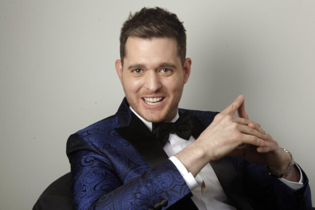 Michael Buble is smiling while seated and wearing a blue tuxedo with a bow tie, HD Desktop Wallpaper