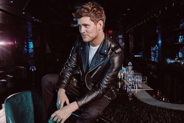 Michael Buble wallpapers showing him seated at a bar wearing a black leather jacket, HD Desktop Wallpaper