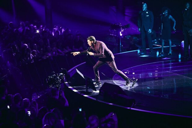 Michael Buble performs passionately on stage during a live concert, HD Desktop Wallpaper