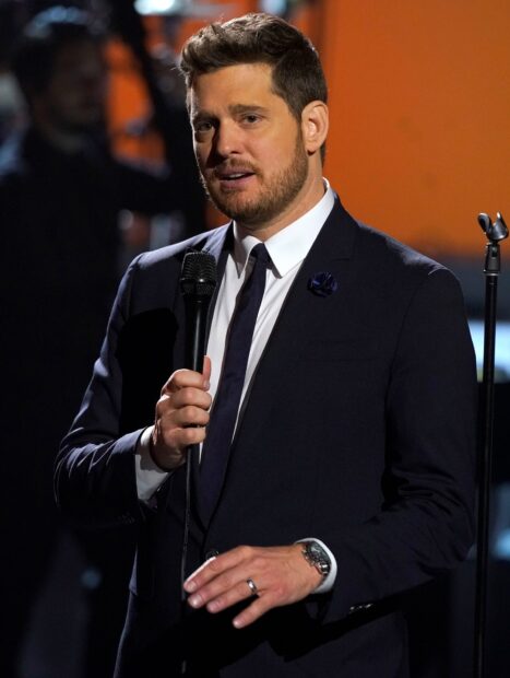 Michael Buble is performing with a microphone in hand wearing a suit, HD Desktop Wallpaper