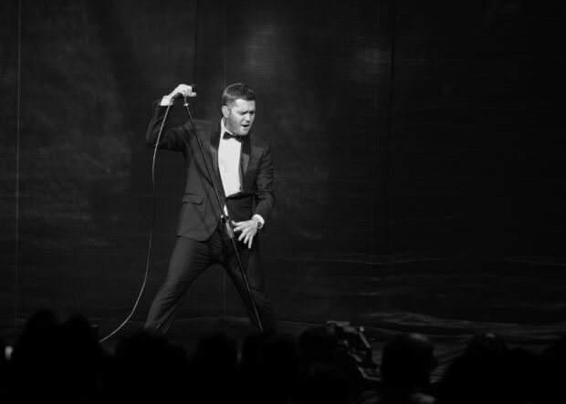 Michael Buble passionately singing into a microphone during a live concert performance, 2K Desktop Wallpaper