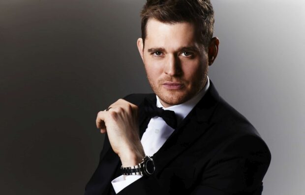 A stylish portrait of Michael Buble wearing a tuxedo and adjusting his bow tie, HD Desktop Wallpaper