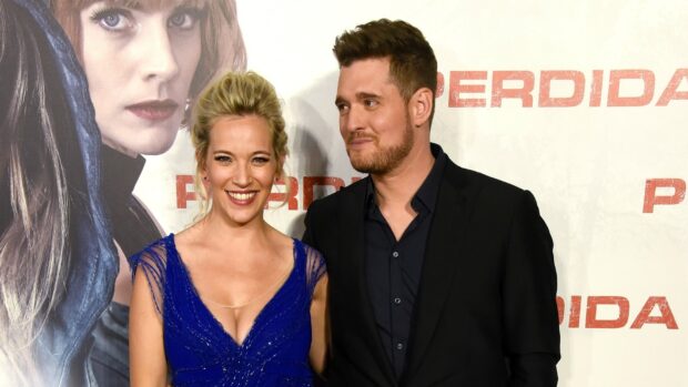Michael Buble with a smiling woman wearing a blue dress at a public event, HD Desktop Wallpaper