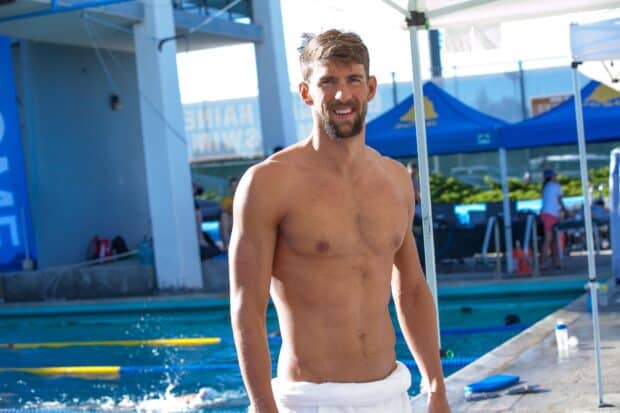 Michael Phelps stands by the poolside showing his athletic physique and confident smile, HD Desktop Wallpaper
