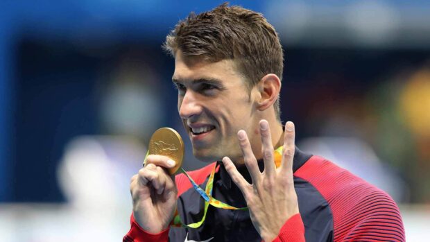 Michael Phelps proudly holds his Olympic gold medal and shows six fingers, HD Desktop Wallpaper