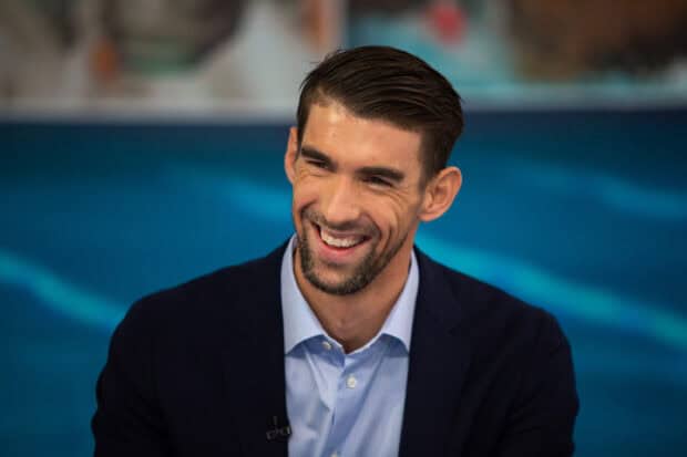 Michael Phelps smiles warmly during an interview by the pool area, 2K Desktop Wallpaper