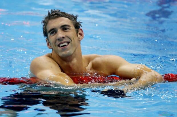 Michael Phelps is smiling and resting in the swimming pool after a race, 2K Desktop Wallpaper