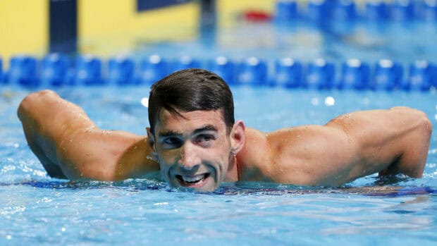 Michael Phelps is smiling and floating in the pool during a swim event, 2K Desktop Wallpaper