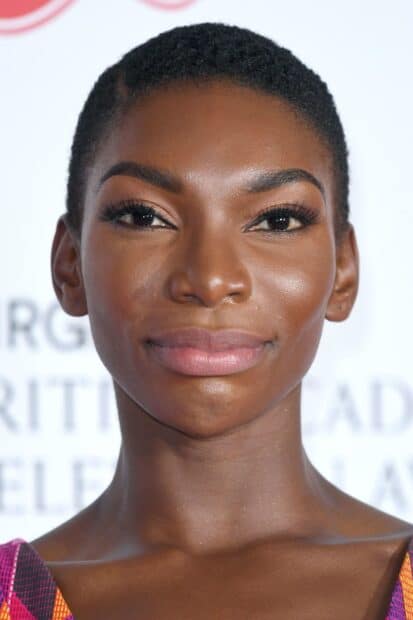 Michaela Coel shows a confident expression in a close up portrait, 2K Desktop Wallpaper