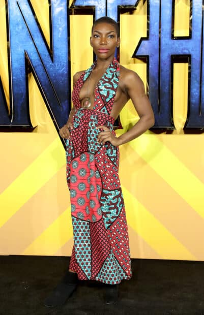 Michaela Coel wears a colorful patterned dress posing confidently at an event, 2K Mobile Wallpaper