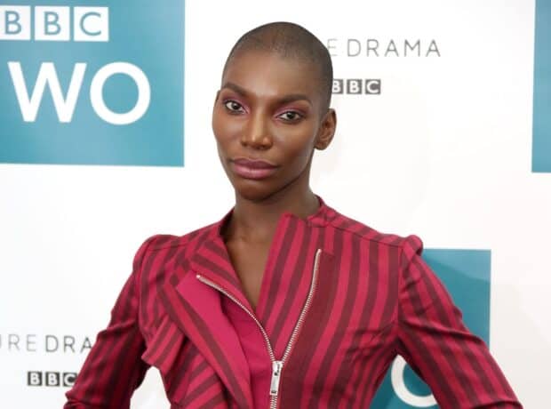 Michaela Coel is posing in a red striped jacket at a BBC event, HD Desktop Wallpaper