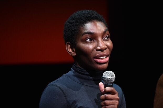 Michaela Coel speaking into a microphone during a public appearance, 2K Desktop Wallpaper