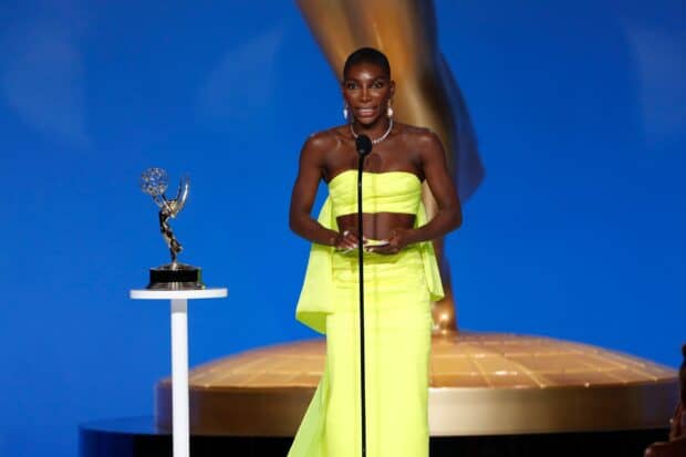 Michaela Coel delivers a speech beside the Emmy trophy on stage, 2K Desktop Wallpaper