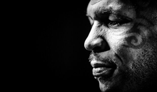 A detailed close up portrait of Mike Tyson showing his facial tattoo and intense expression, HD Desktop Wallpaper