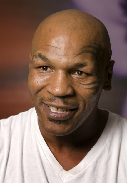 Mike Tyson is smiling with his face tattoo visible in this close up, HD Mobile Wallpaper