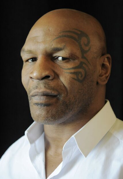 A detailed close up portrait of Mike Tyson showing his facial tattoo and intense expression, 2K Desktop Wallpaper