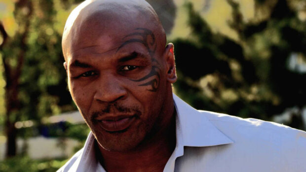 Mike Tyson with facial tattoo in a white shirt outdoors, 2K Desktop Wallpaper