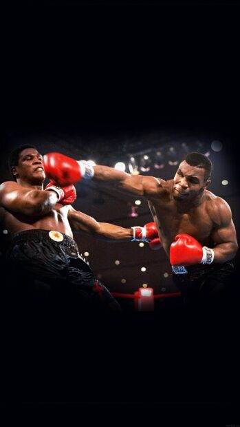 Mike Tyson delivers a powerful punch to his opponent during a boxing match, HD Phone Wallpaper
